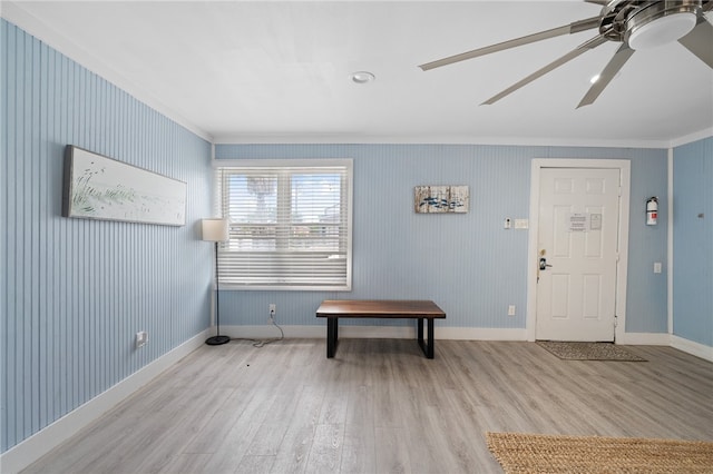 entryway featuring light wood-type flooring, ceiling fan, and crown molding