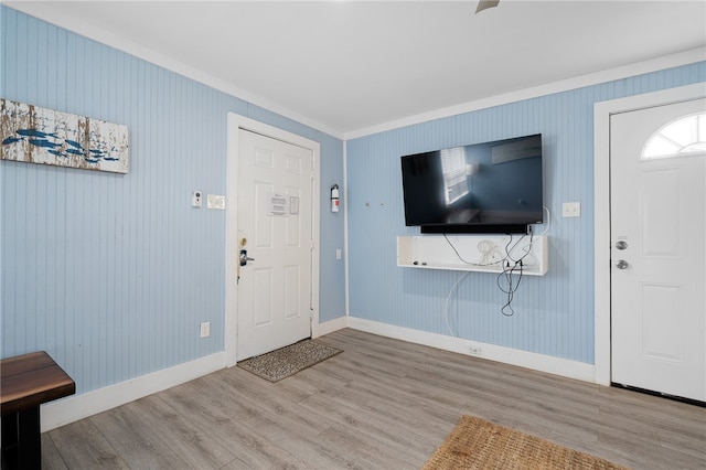 entryway with light hardwood / wood-style flooring and ornamental molding