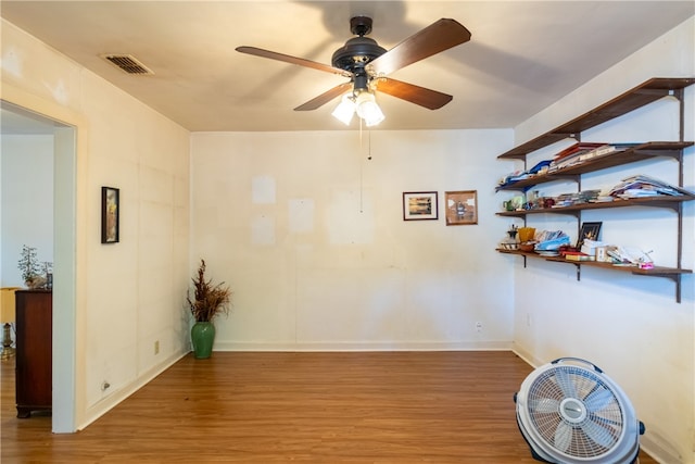 spare room featuring hardwood / wood-style floors and ceiling fan