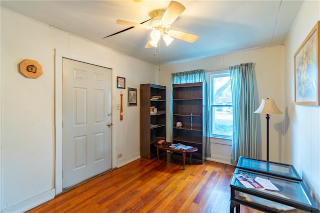 interior space featuring hardwood / wood-style flooring, ceiling fan, and ornamental molding