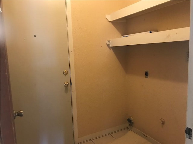 washroom with laundry area, light tile patterned floors, baseboards, and electric dryer hookup