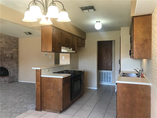 kitchen featuring black / electric stove, a sink, visible vents, and under cabinet range hood