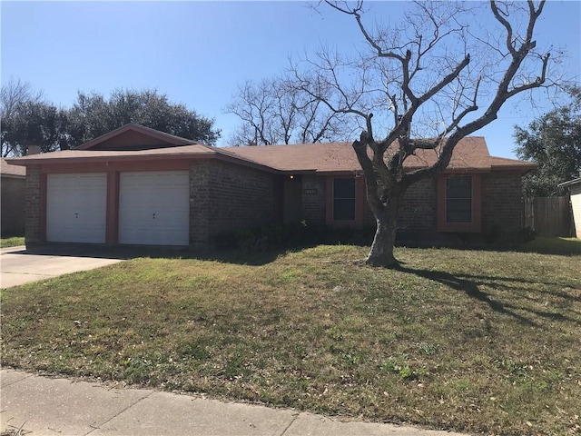 ranch-style house with an attached garage, concrete driveway, brick siding, and a front yard