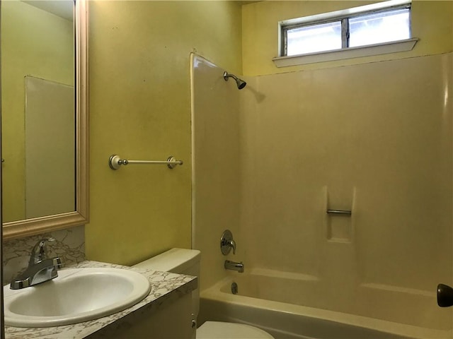 bathroom featuring toilet, shower / tub combination, and vanity