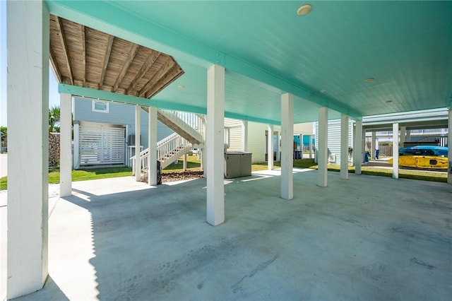 view of patio / terrace featuring a carport and stairway