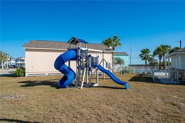 community play area with fence and a lawn