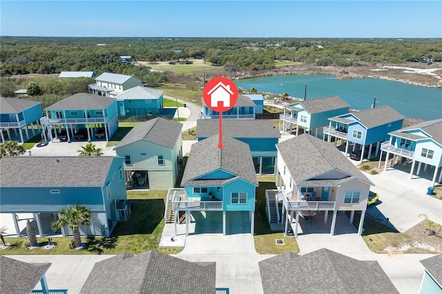 drone / aerial view featuring a residential view and a water view