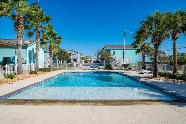 community pool featuring a patio area and fence