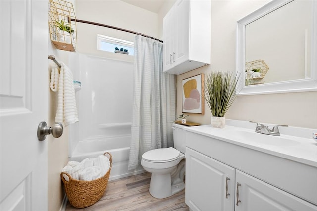 bathroom with shower / bath combination with curtain, toilet, vanity, and wood finished floors