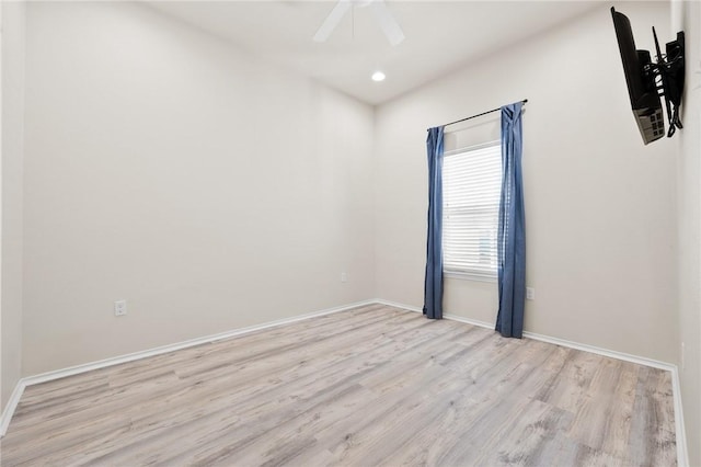 empty room featuring recessed lighting, a ceiling fan, baseboards, and light wood finished floors