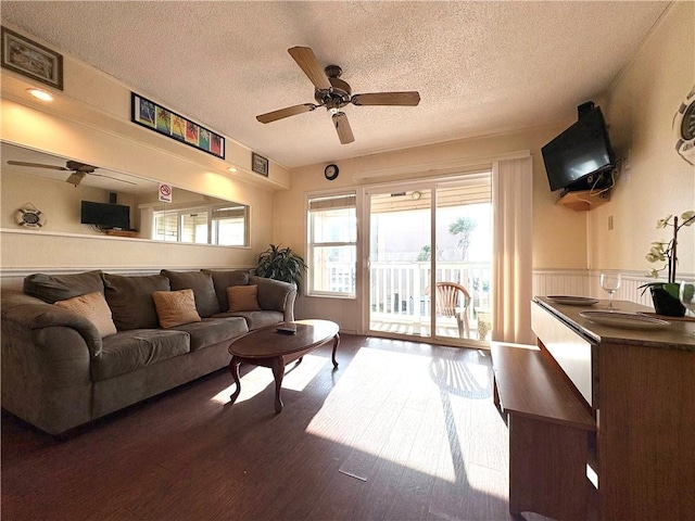 3938 Surfside Unit 3233, Corpus Christi, TX 78402 - living room featuring a textured ceiling, a ceiling fan, and dark wood-style flooring