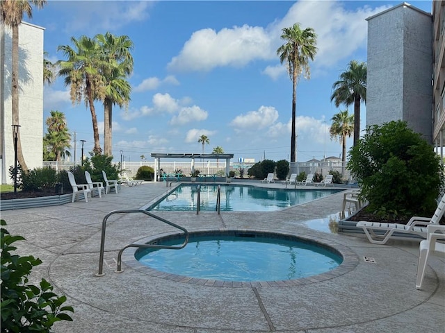 3938 Surfside Unit 3233, Corpus Christi, TX 78402 - community pool featuring a community hot tub and a patio area