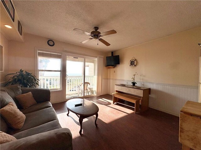 3938 Surfside Unit 3233, Corpus Christi, TX 78402 - living room with a wainscoted wall, ceiling fan, wood finished floors, and a textured ceiling