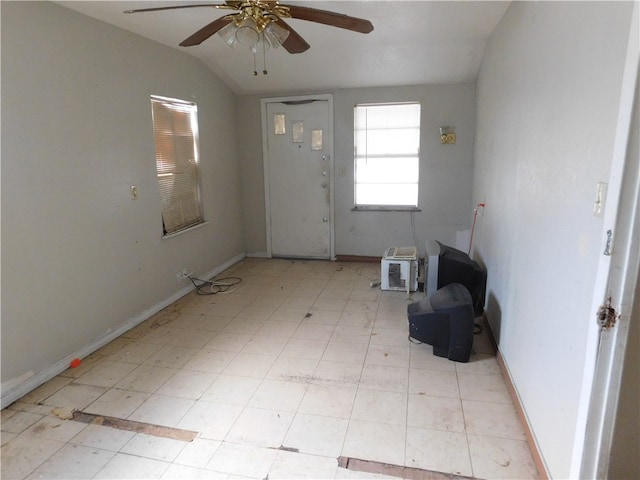 foyer with ceiling fan and lofted ceiling