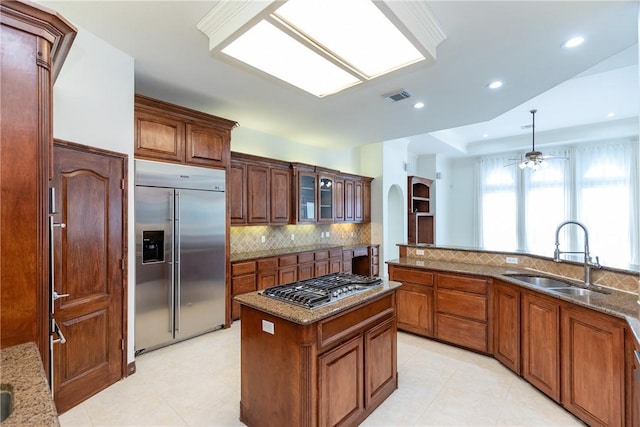 4 E Bar Le Doc Dr, Corpus Christi, TX 78414 - kitchen with stainless steel appliances, a ceiling fan, backsplash, stone counters, and recessed lighting