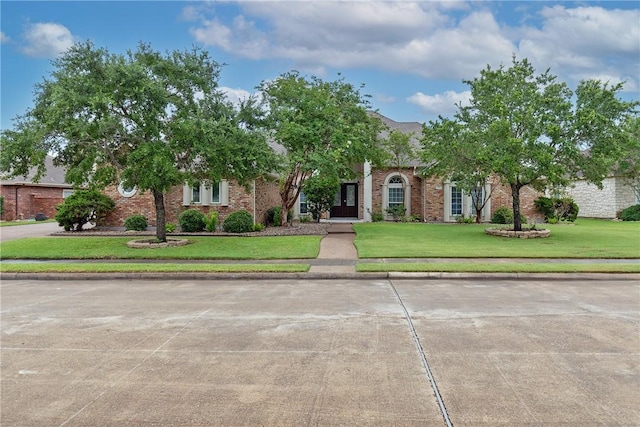 4 E Bar Le Doc Dr, Corpus Christi, TX 78414 - obstructed view of property with a front yard and brick siding