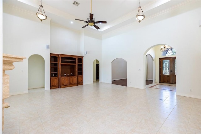 4 E Bar Le Doc Dr, Corpus Christi, TX 78414 - unfurnished living room with arched walkways, a high ceiling, ceiling fan, ornamental molding, and tile patterned flooring