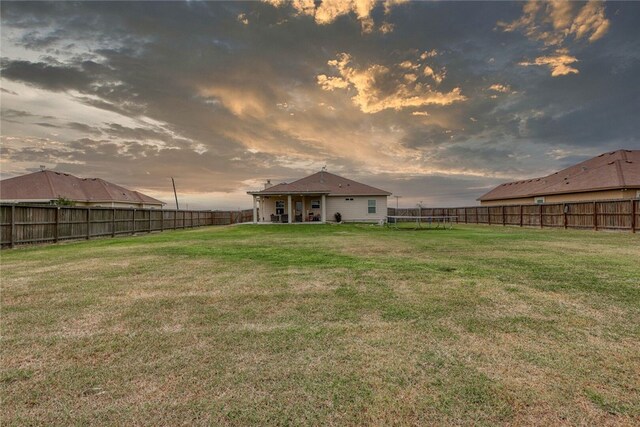 view of yard at dusk