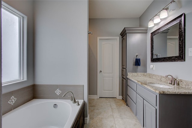 bathroom featuring tile patterned floors, vanity, and a bathing tub