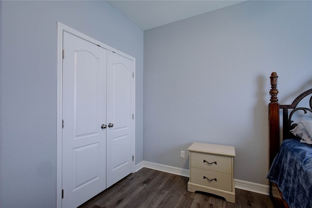 bedroom featuring dark wood-type flooring and a closet