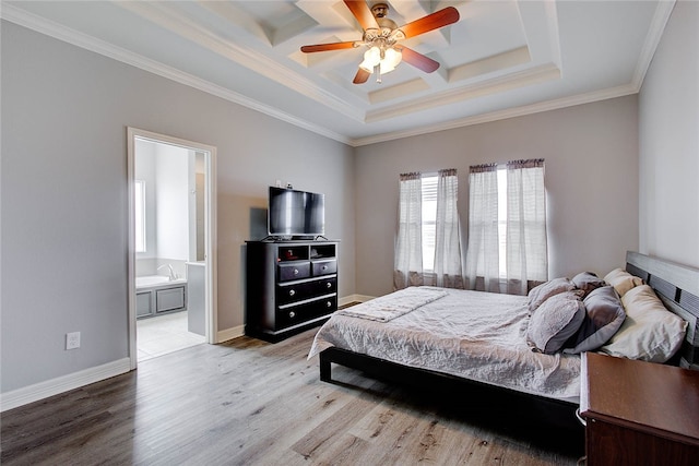 bedroom featuring ensuite bathroom, ornamental molding, ceiling fan, a raised ceiling, and light hardwood / wood-style flooring