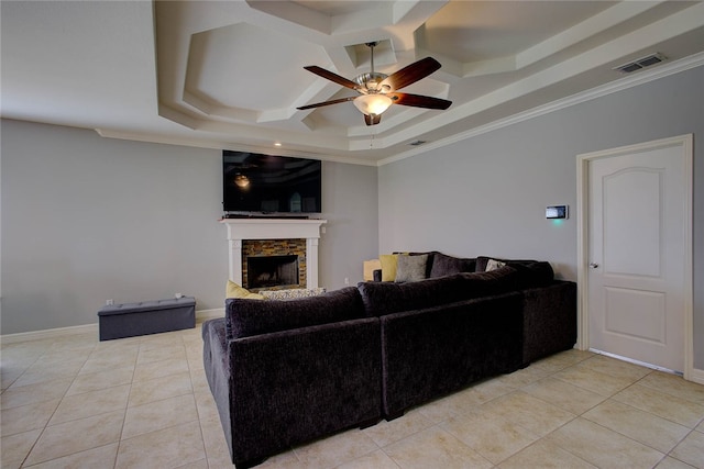 living room featuring crown molding, a stone fireplace, light tile patterned floors, a raised ceiling, and ceiling fan