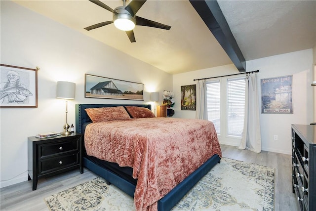 bedroom with vaulted ceiling with beams, light hardwood / wood-style flooring, and ceiling fan