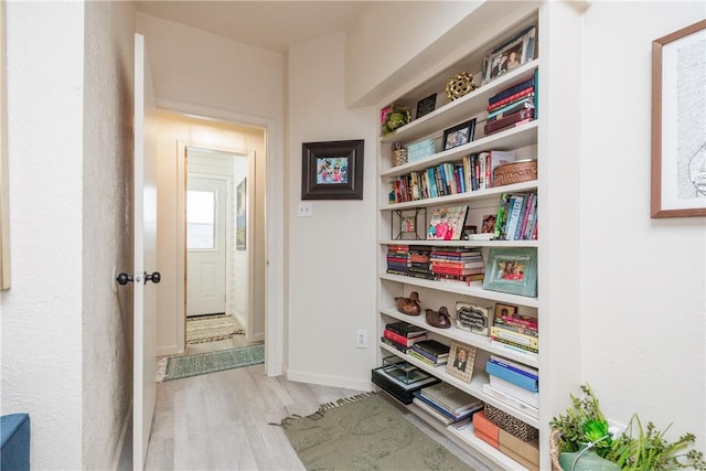 hall with light hardwood / wood-style flooring