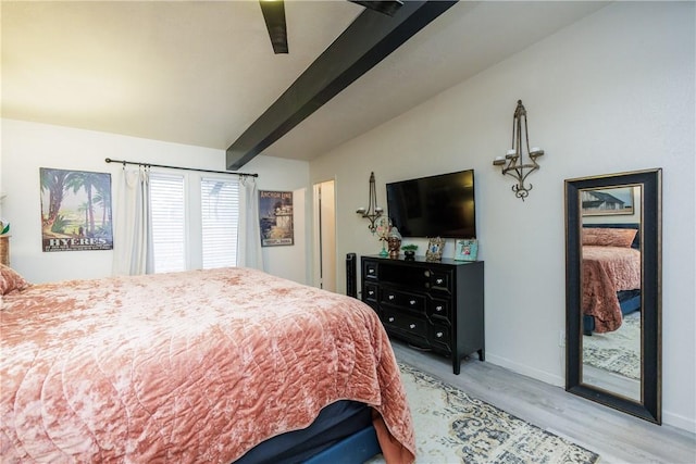 bedroom with lofted ceiling with beams, ceiling fan, and light wood-type flooring