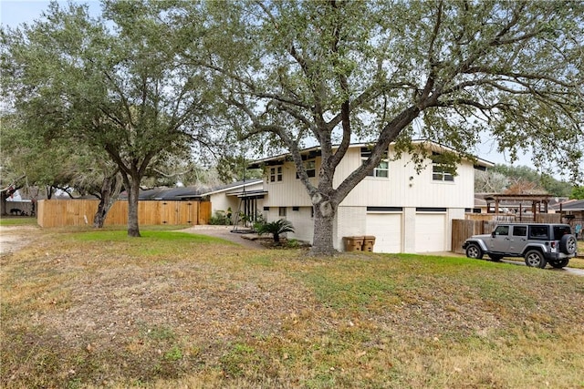 exterior space featuring a garage and a front lawn