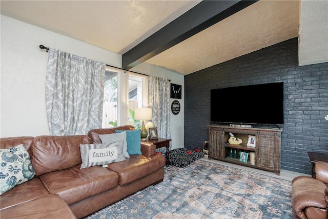 living room featuring brick wall, lofted ceiling with beams, and a textured ceiling