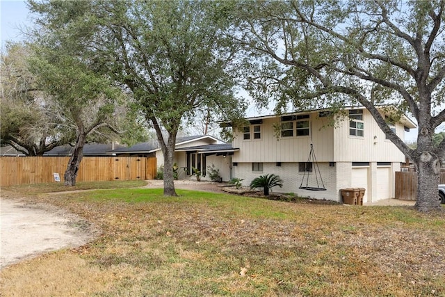 view of front of property with a garage and a front yard