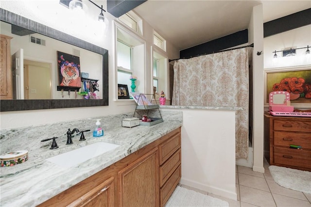 bathroom with a shower with shower curtain, vanity, and tile patterned flooring