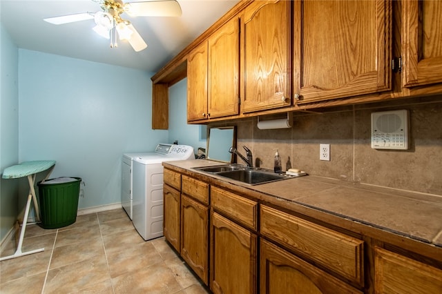 clothes washing area with cabinets, sink, ceiling fan, light tile patterned floors, and washing machine and dryer