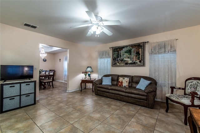 living room with ceiling fan and light tile patterned floors