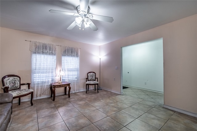 living area featuring ceiling fan and light tile patterned floors