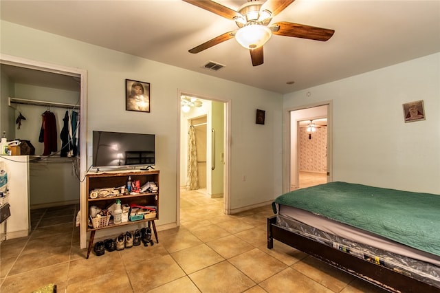 bedroom featuring a closet, light tile patterned floors, and ceiling fan