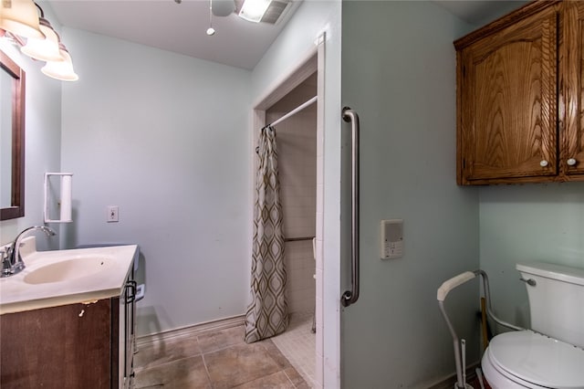 bathroom with toilet, vanity, a shower with shower curtain, and tile patterned floors