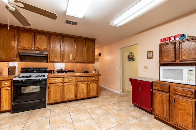 kitchen with ceiling fan, black range with gas cooktop, and light tile patterned floors