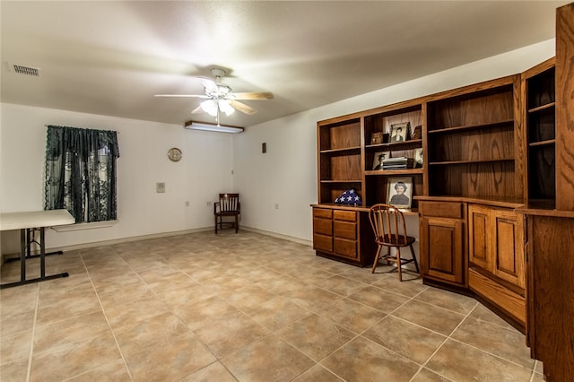 tiled office space featuring built in desk and ceiling fan