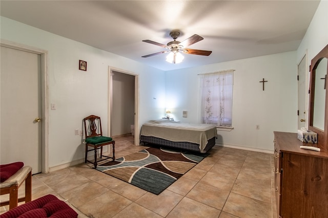 tiled bedroom with ceiling fan