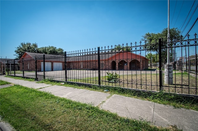 view of gate featuring a yard