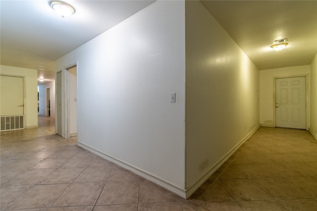 corridor with light tile patterned flooring