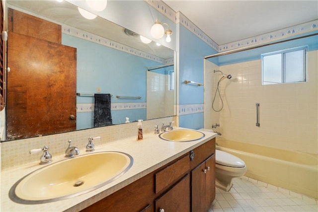 full bathroom with tiled shower / bath, tasteful backsplash, vanity, toilet, and tile patterned floors