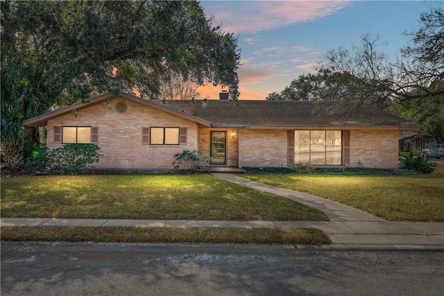 ranch-style house with a lawn