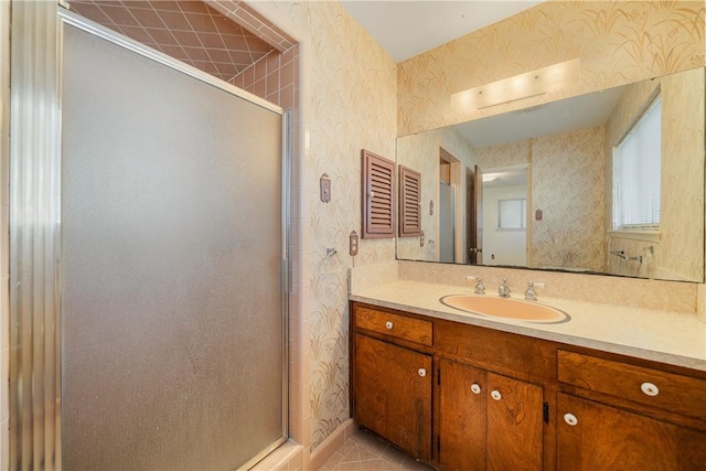 bathroom with tile patterned floors, vanity, and an enclosed shower