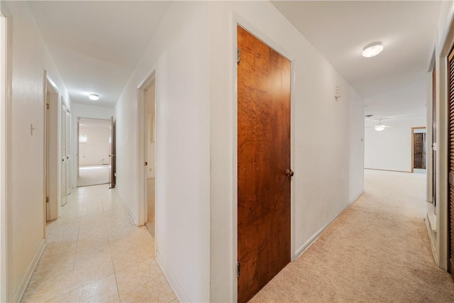 hall featuring light tile patterned flooring