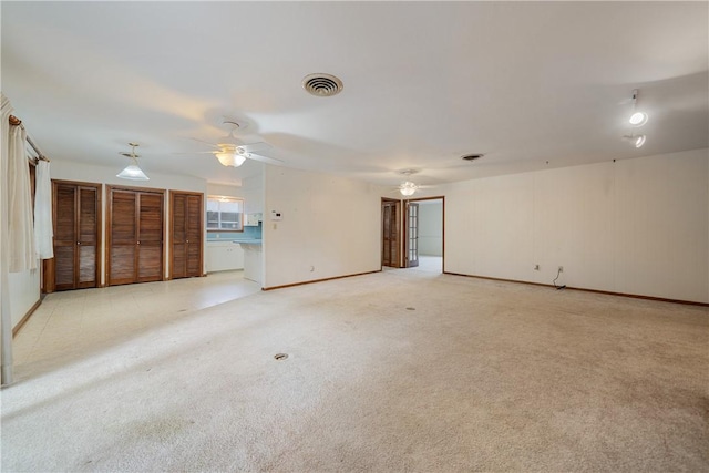 carpeted empty room with ceiling fan