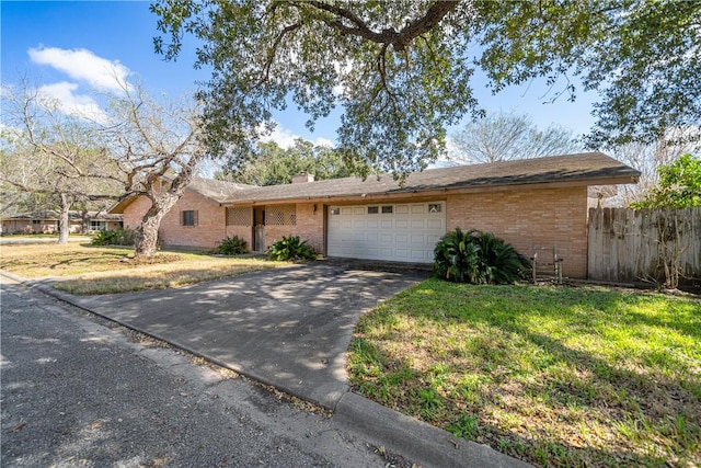 single story home featuring a garage and a front yard