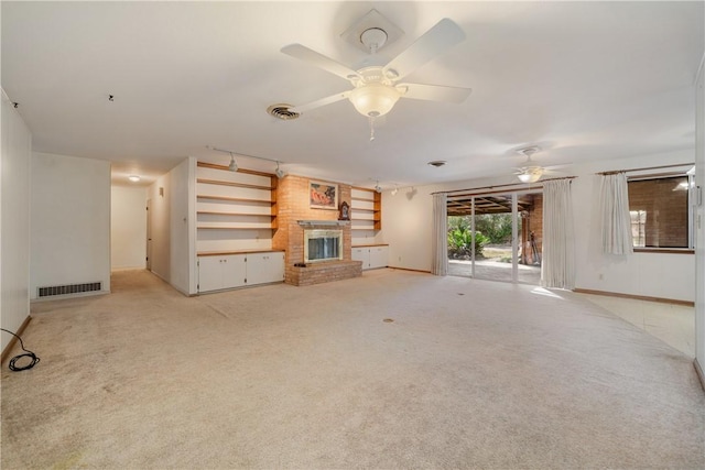 unfurnished living room with ceiling fan, light carpet, and a fireplace